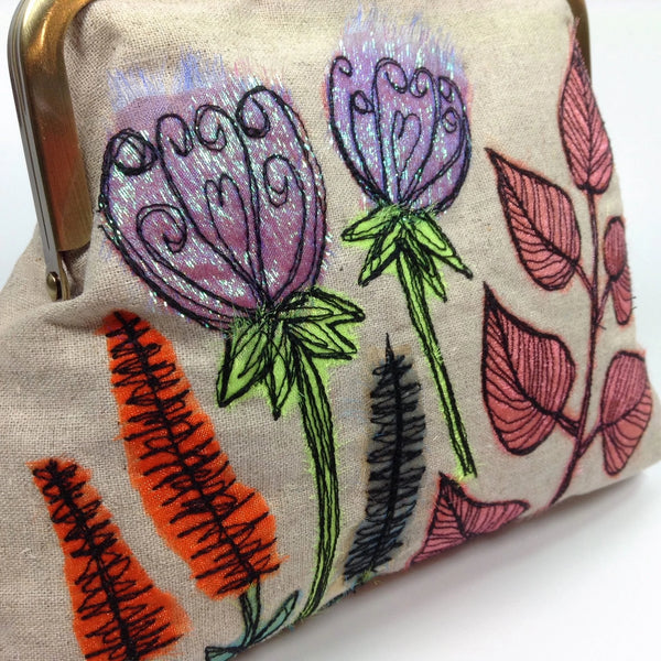 Detail of embroidered fibre art flowers on linen bag by Textile artist Tors Duce