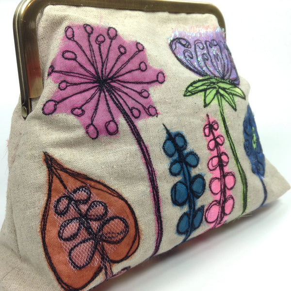 Seed heads, leaves and flowers drawn with thread on designer contemporary bag