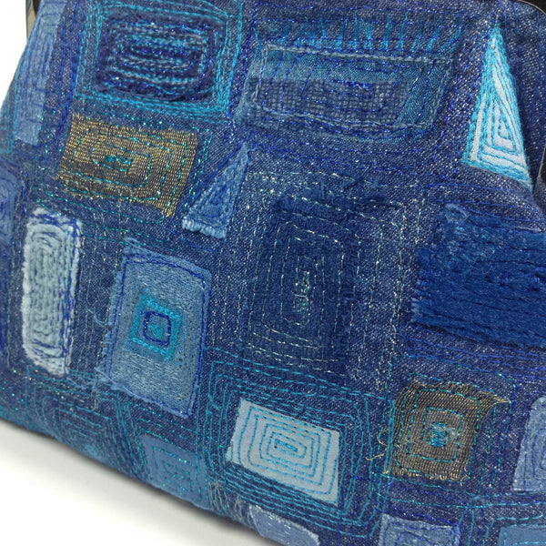 Detail of free machine embroidery of denim, cotton, silk and velvet