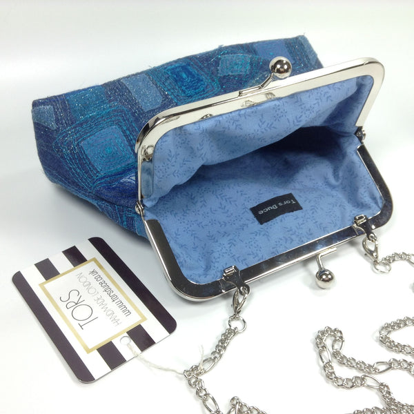 Blue cotton lining and chain strap of denim clutch or shoulder frame purse bag